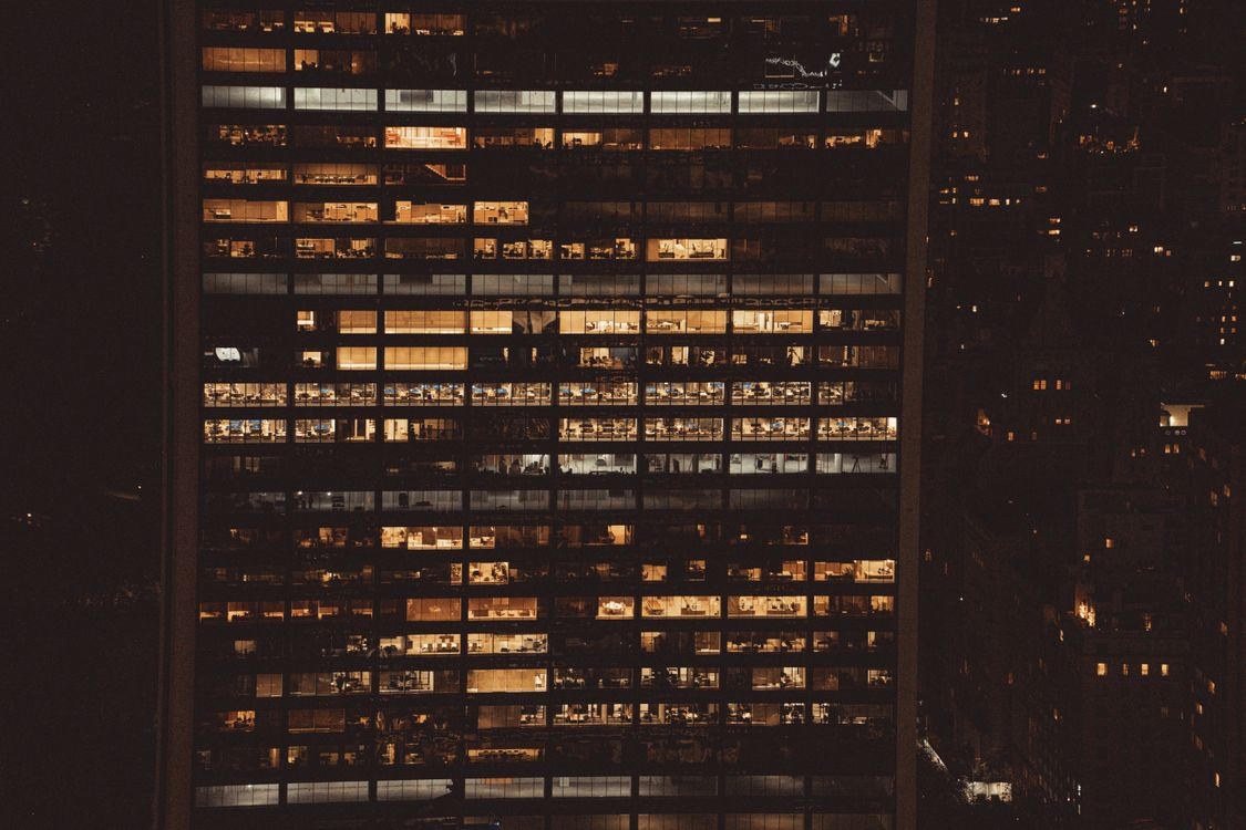 Office tower at night — lit floors, city glass