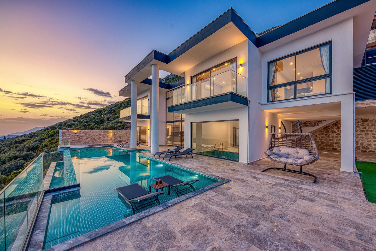 Resort terrace and infinity pool at blue hour