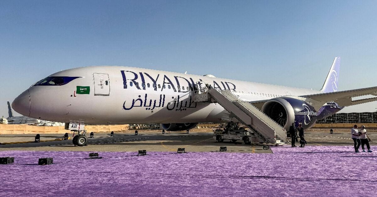 Riyadh Air Boeing 787 on the tarmac — bilingual livery, air-stairs, purple carpet